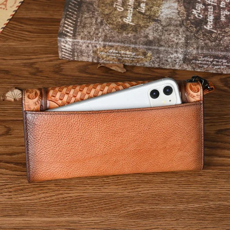 Women's brown genuine leather tri-fold wallet with embossed floral pattern showing open compartments