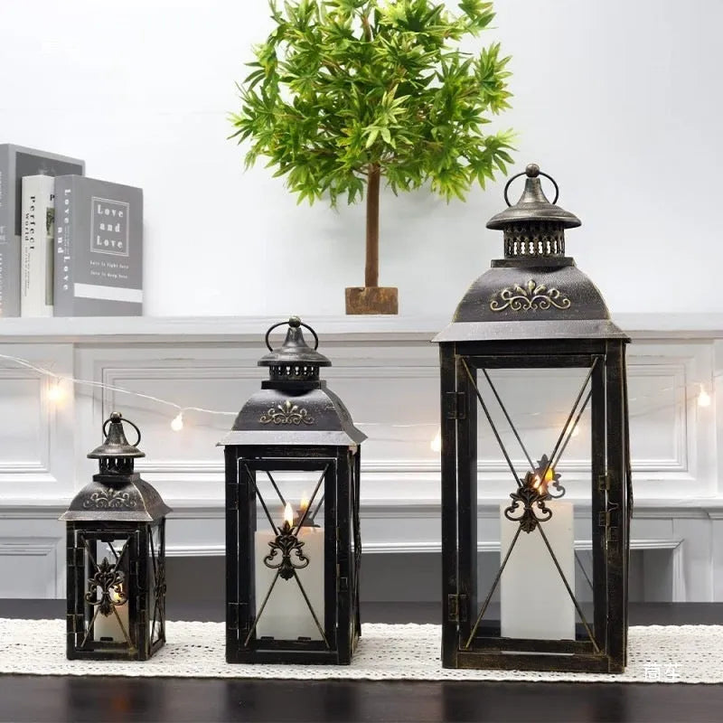 European black and white wrought iron floor-standing storm lantern with tempered glass in three sizes for courtyard decoration.