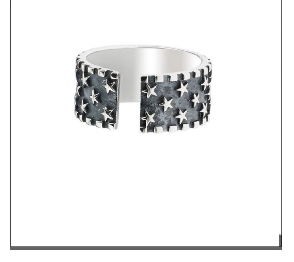 Adjustable silver ring with geometric five pointed star pattern on adjustable band