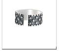Adjustable silver ring with geometric five pointed star pattern on adjustable band