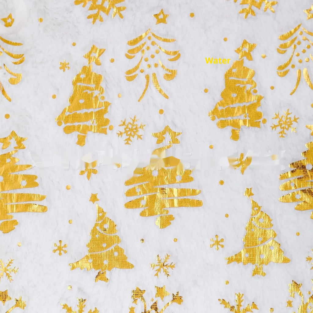 Plush red Christmas tree group mat with white snowflake XINGX pattern on a wooden floor.
