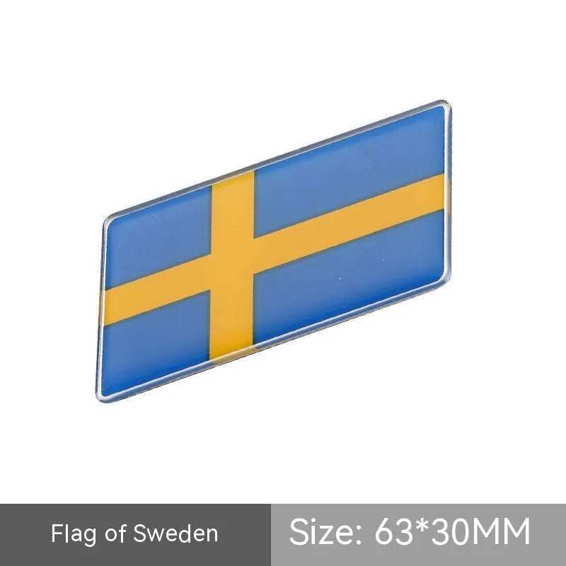 Aluminium metal car sticker with national flag design in a parallelogram shape.