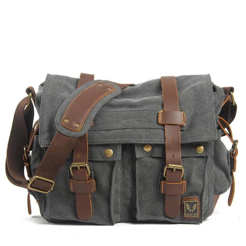 Men's brown retro canvas crossbody shoulder bag with cowhide trim, shown with flap open revealing internal zip pockets.