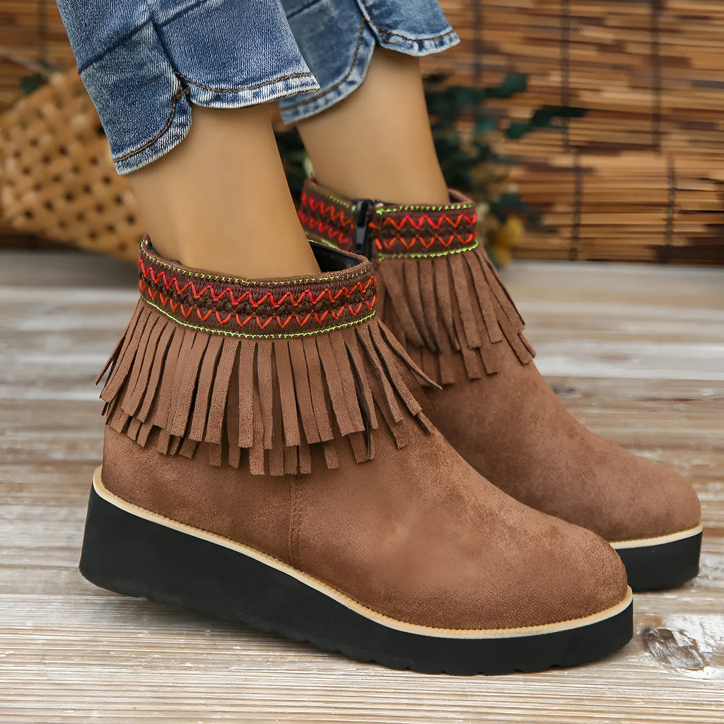 Women's black suede wedge ankle boots with side zip, tassel, and thick rubber sole.