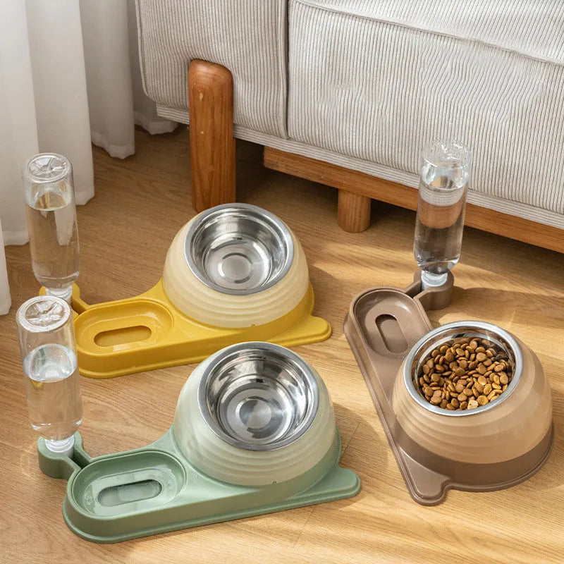 Brown elevated cat bowl with attached water dispenser bottle on a wooden floor.