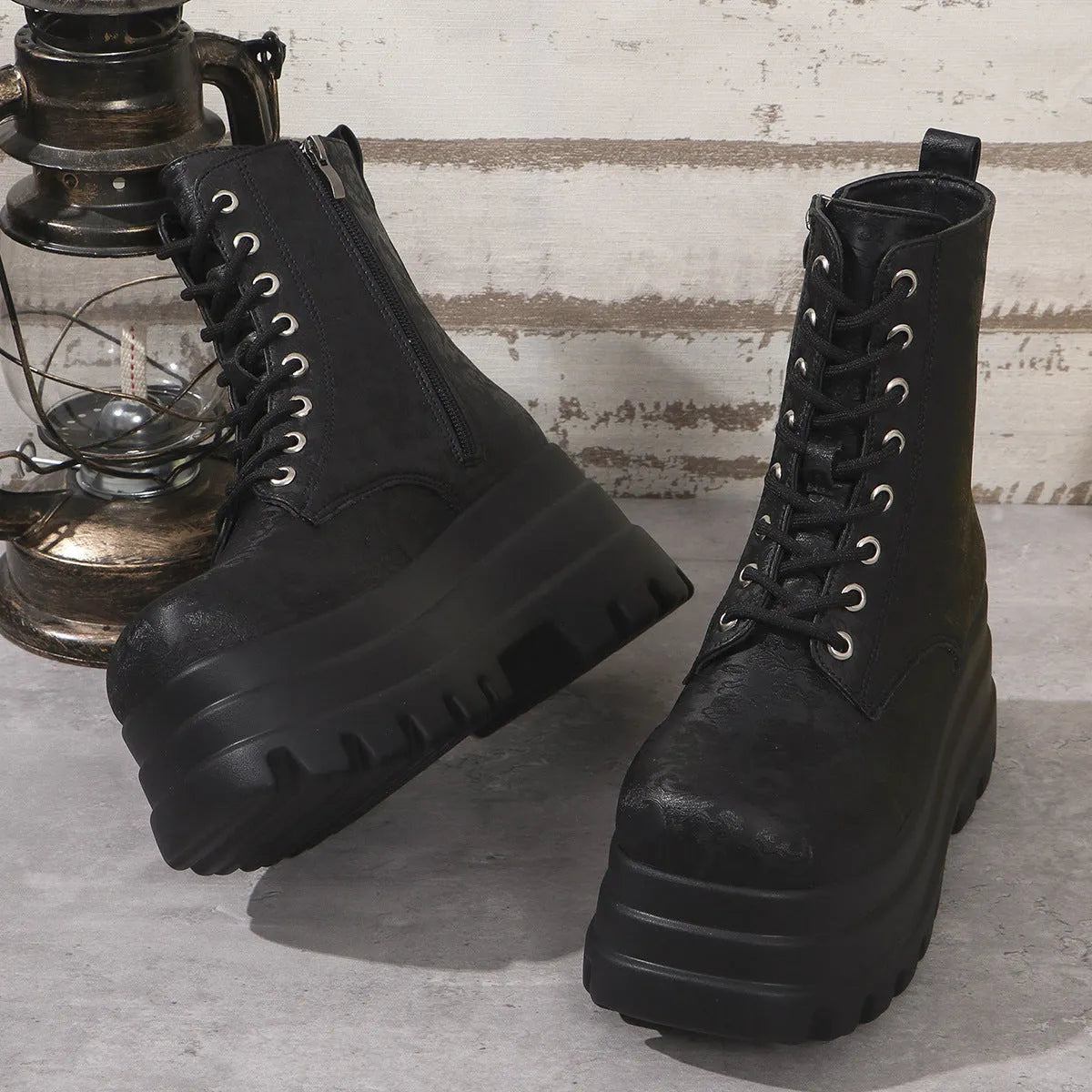 Women's black retro platform boots with patchwork round toe and side zip.