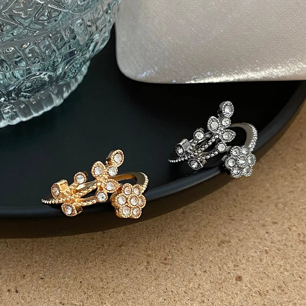 Gold and white copper open ring with diamond-finished flower and leaf design for women.