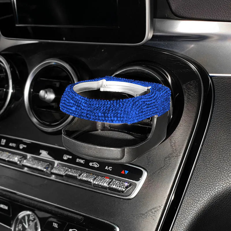 White diamond decorated ABS plastic car vent cup holder mounted in a car air vent.