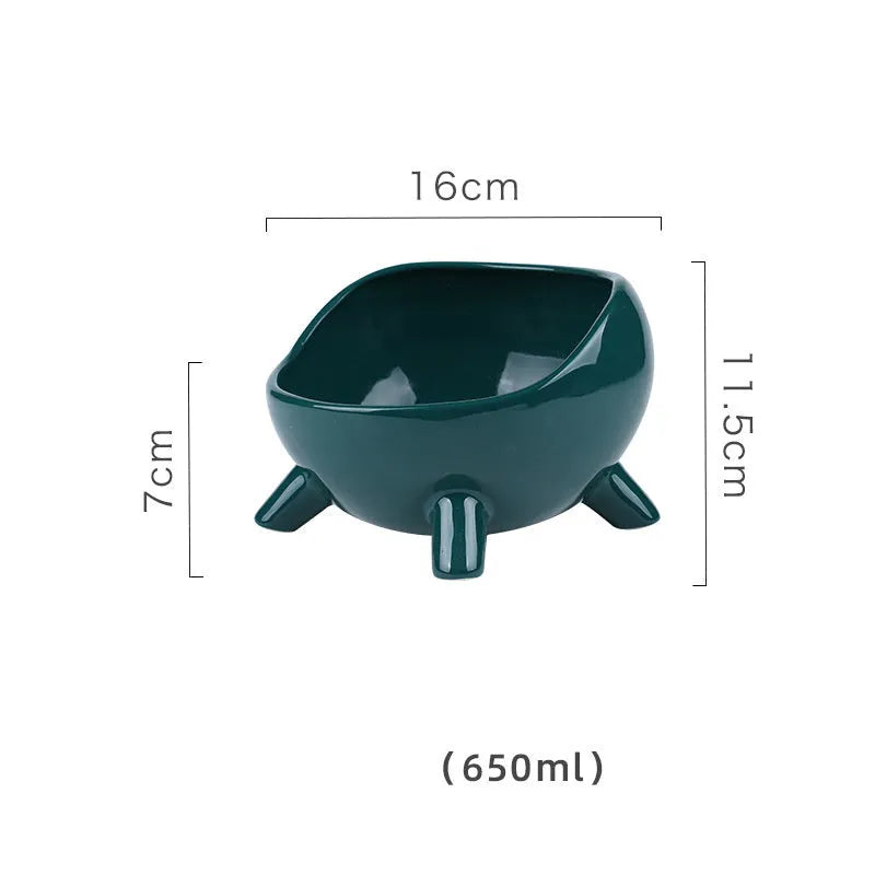 Green ceramic cat food bowl with four-leg stability base on wooden floor