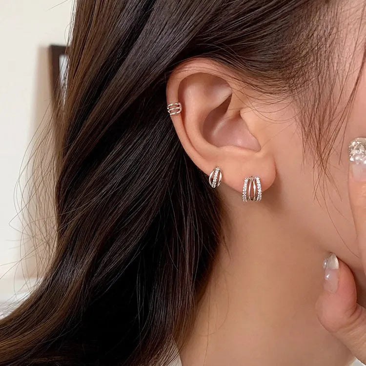 A pair of modern geometric drop earrings made from electroplated 925 silver, shown in large, medium, and small size options.