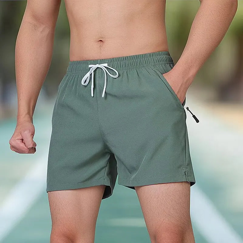 Man wearing black high-waist polyester fitness training shorts with a drawstring waist.