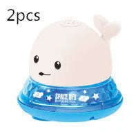 Whale-shaped electric bath toy spraying water with flashing lights, on a blue base.