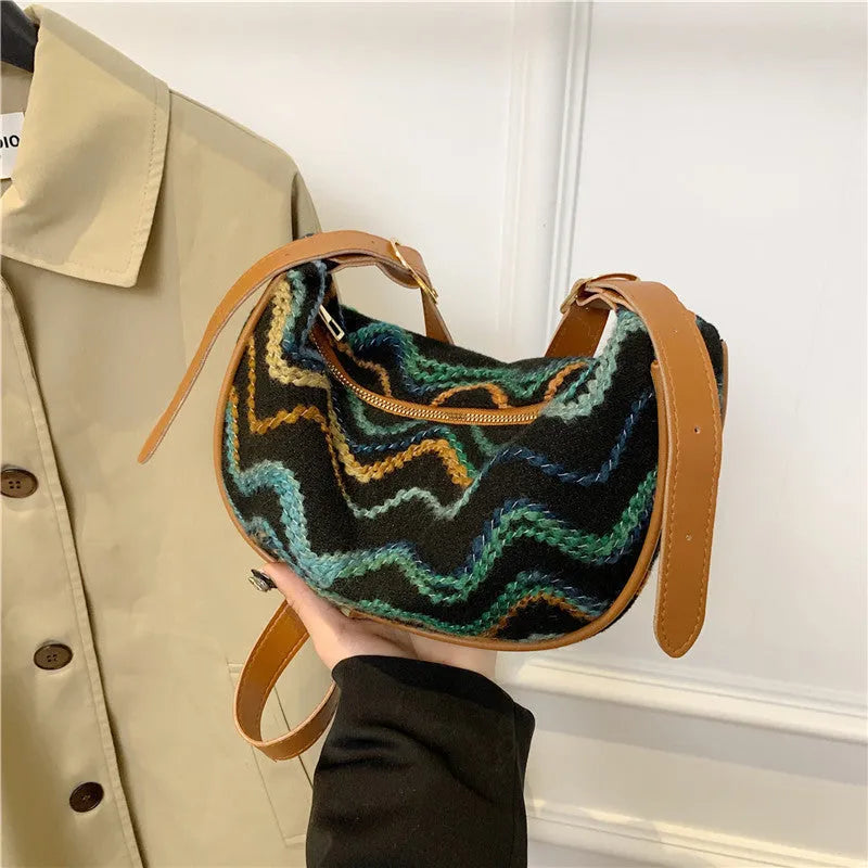 Knitted straw woven crossbody bag showing woven texture and internal organisation pockets
