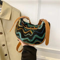 Knitted straw woven crossbody bag showing woven texture and internal organisation pockets