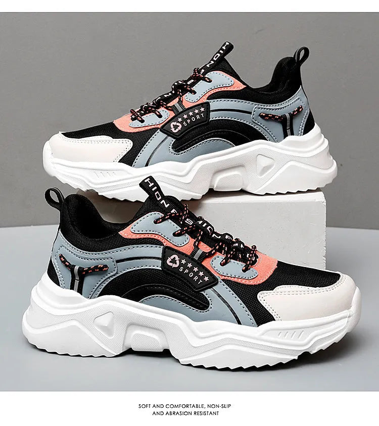 Women's white thick-soled casual sports shoes with mesh upper and buckle detail.