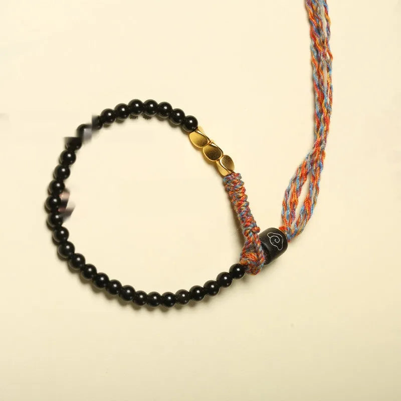 Hand-woven obsidian carrying strap bracelet showing braided detail and adjustable 15.5-16cm length