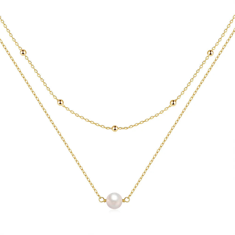 S925 sterling silver double layer necklace with twin pearls in gold or white gold finish featuring geometric pendant and ball bead chain.