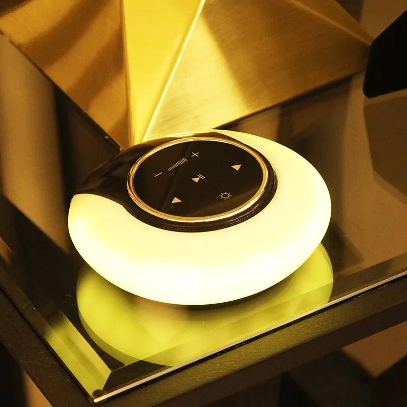 Blue Bluetooth desk lamp speaker with touch controls showing white, yellow, and blue lighting options