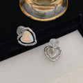 Women's alloy geometric heart earrings in ear clip and ear stud styles with electroplated finish