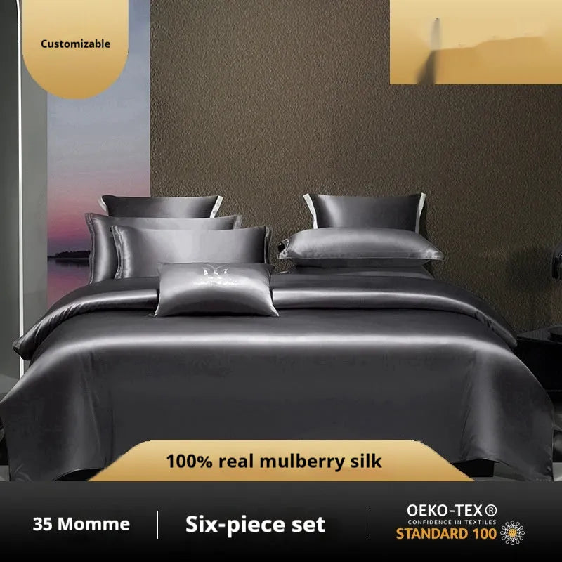 Silk four-piece quilt cover set in a solid colour displayed on a bed, showing the quilt cover and matching pillowcases.