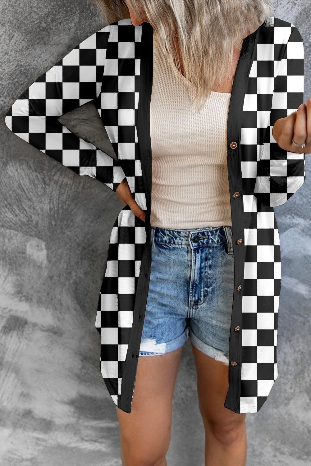 Long grey plaid knitted cardigan coat on a model, showing loose fit and regular sleeves.