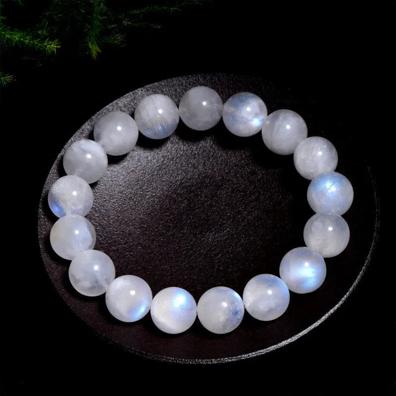 Natural blue moonlight round bead moonstone bracelet showing polished stone beads on wrist