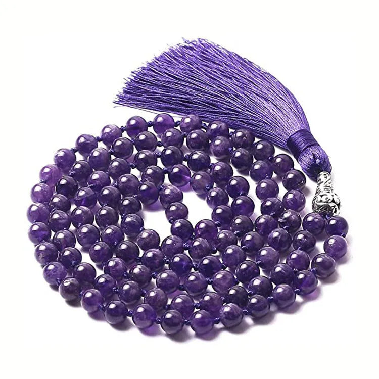 Long agate tassel necklace with geometric stone beads in various colours on a neutral background.