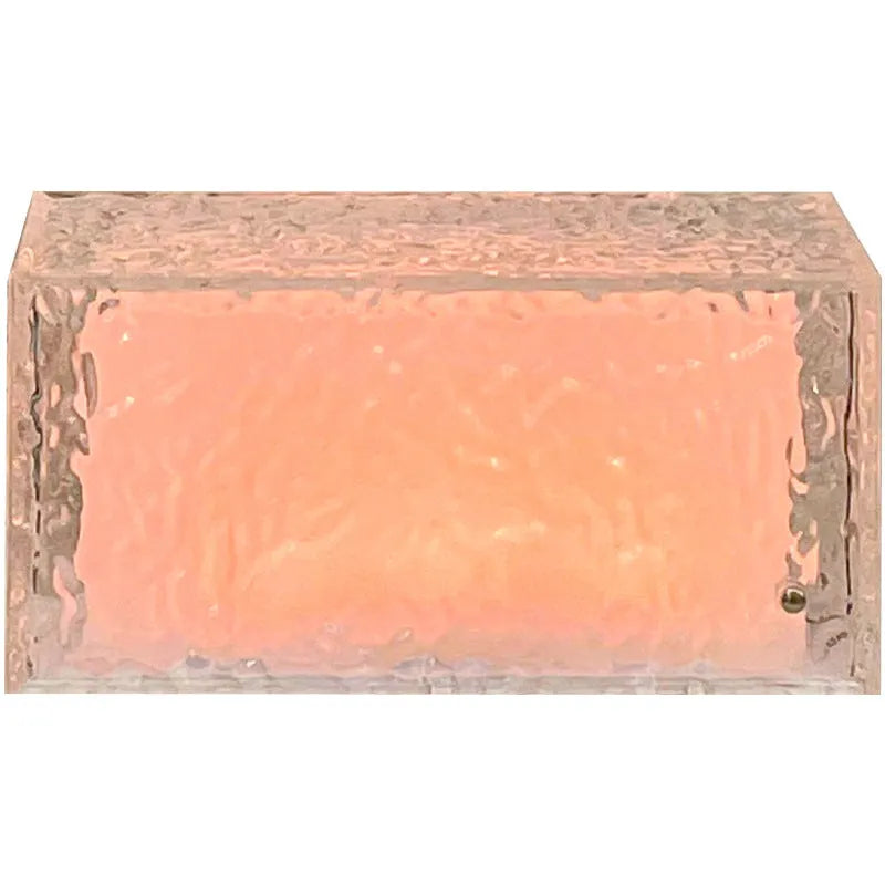 Clear geometric ice cube-shaped night lamp with multi-colour LED glow on a desk.