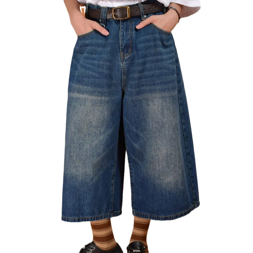 Man wearing blue loose straight-leg denim shorts for summer.