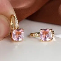 Square geometric ear hook earrings with zircon stones in an electroplated copper setting.