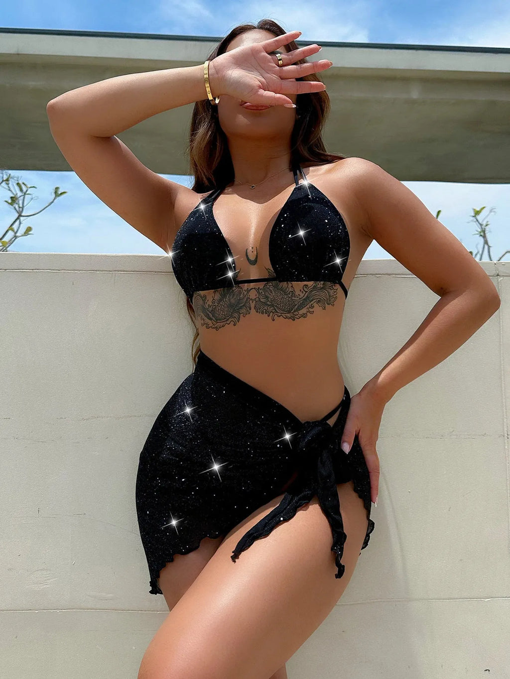 Black women's three-piece bikini swimsuit set with top and shorts.