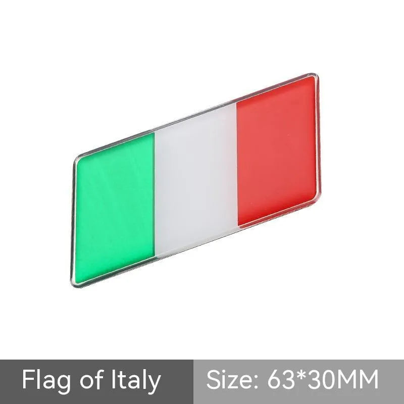 Aluminium metal car sticker with national flag design in a parallelogram shape.