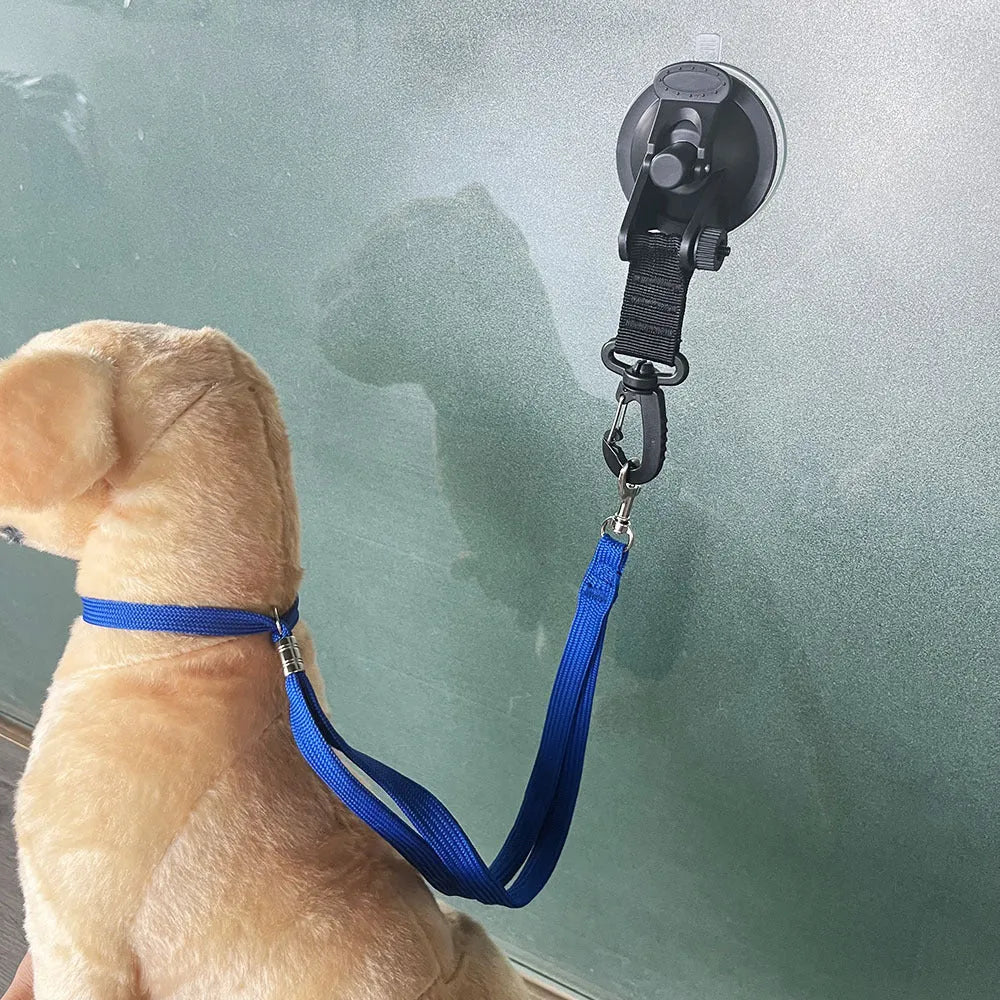 Black and blue pet bathing restraint with four adjustable suction cup cuffs for dogs.