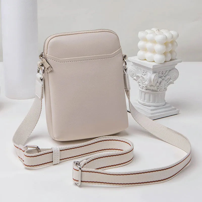 Solid colour small crossbody mobile phone bag in beige, showing front view and adjustable strap.