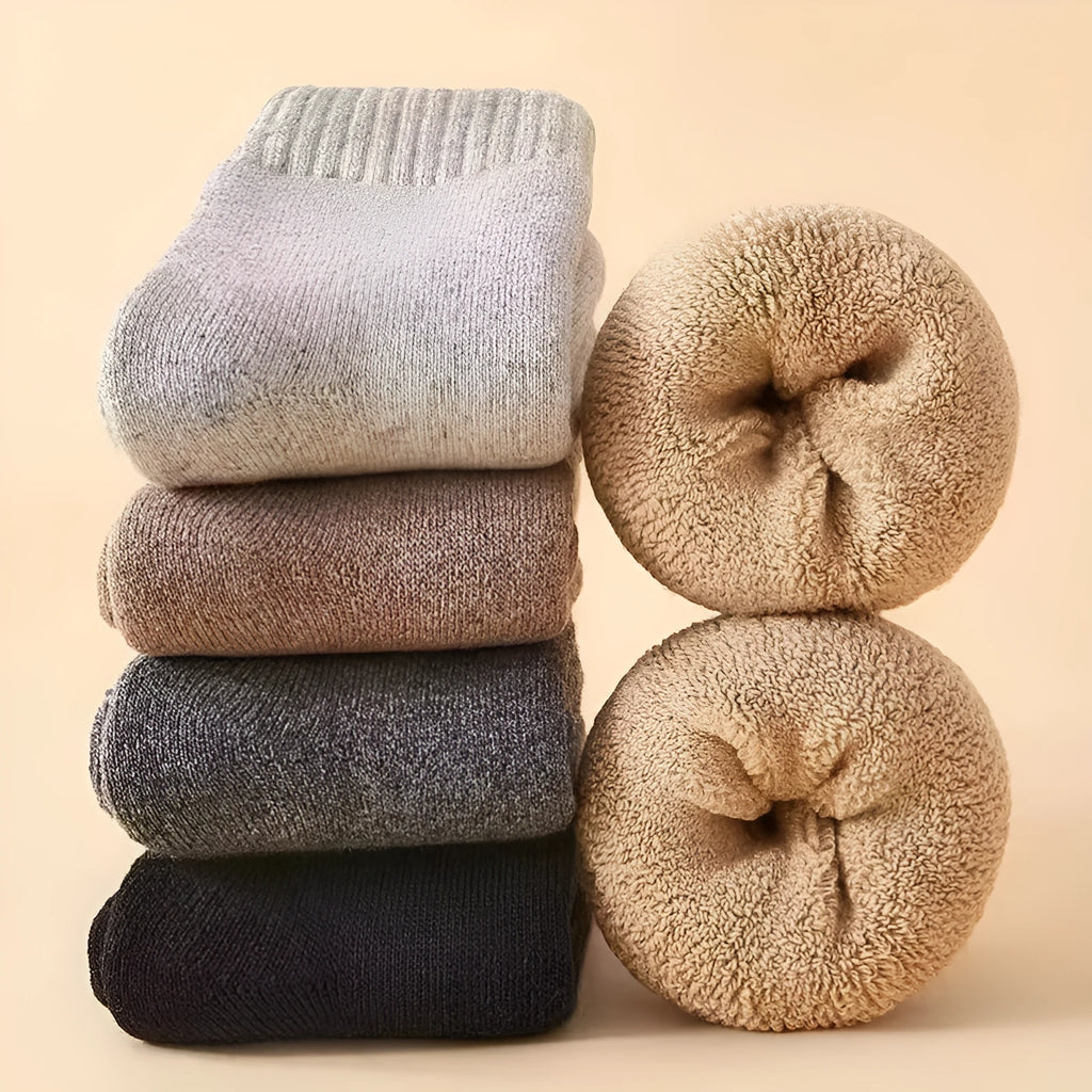 Pair of thick solid-colour wool socks with a merino midsole, shown with a storage box.