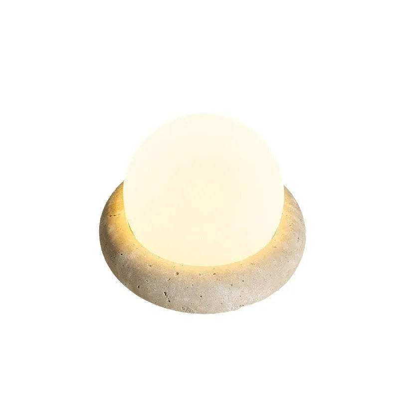 Cream modern bedside table lamp with remote control on wooden surface