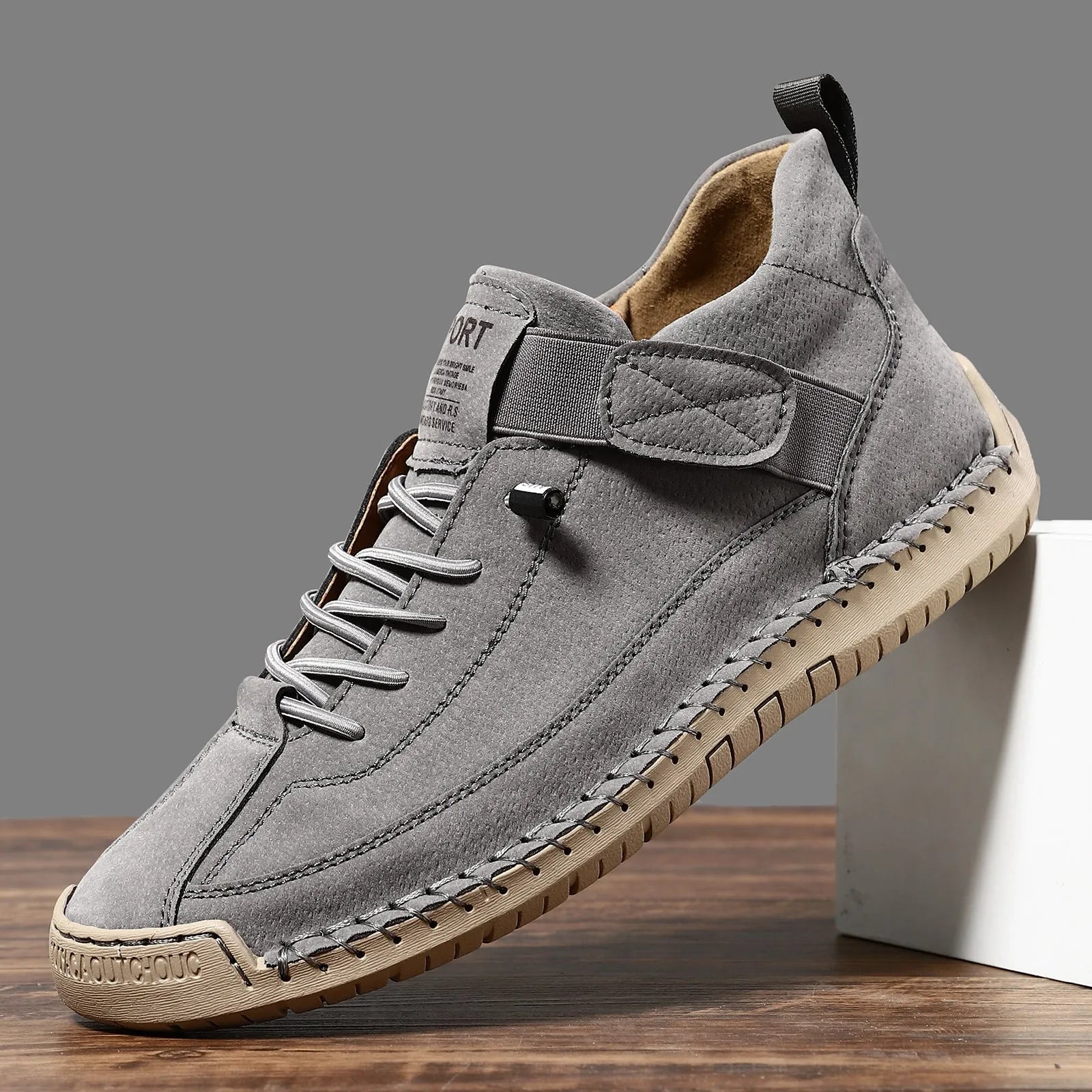 Men's mid-top Martin boot in khaki colour with tooling stitching on the rubber sole.