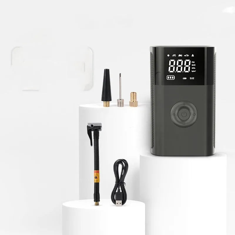 Wireless digital handheld tyre pump with LCD screen, black ABS body, and attached air hose with nozzles.