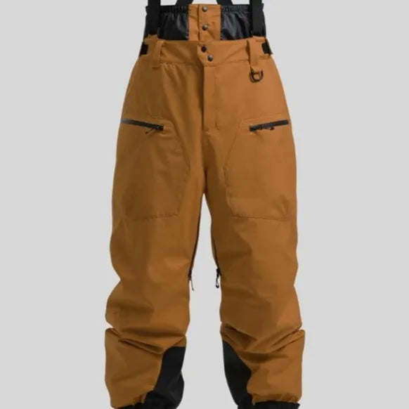 Man wearing black waterproof ski trousers with an adjustable strap on a snowy slope.