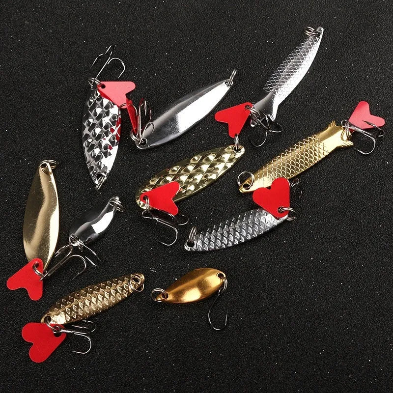 Pineapple sequin box containing metal fishing lure components in gold and silver colours