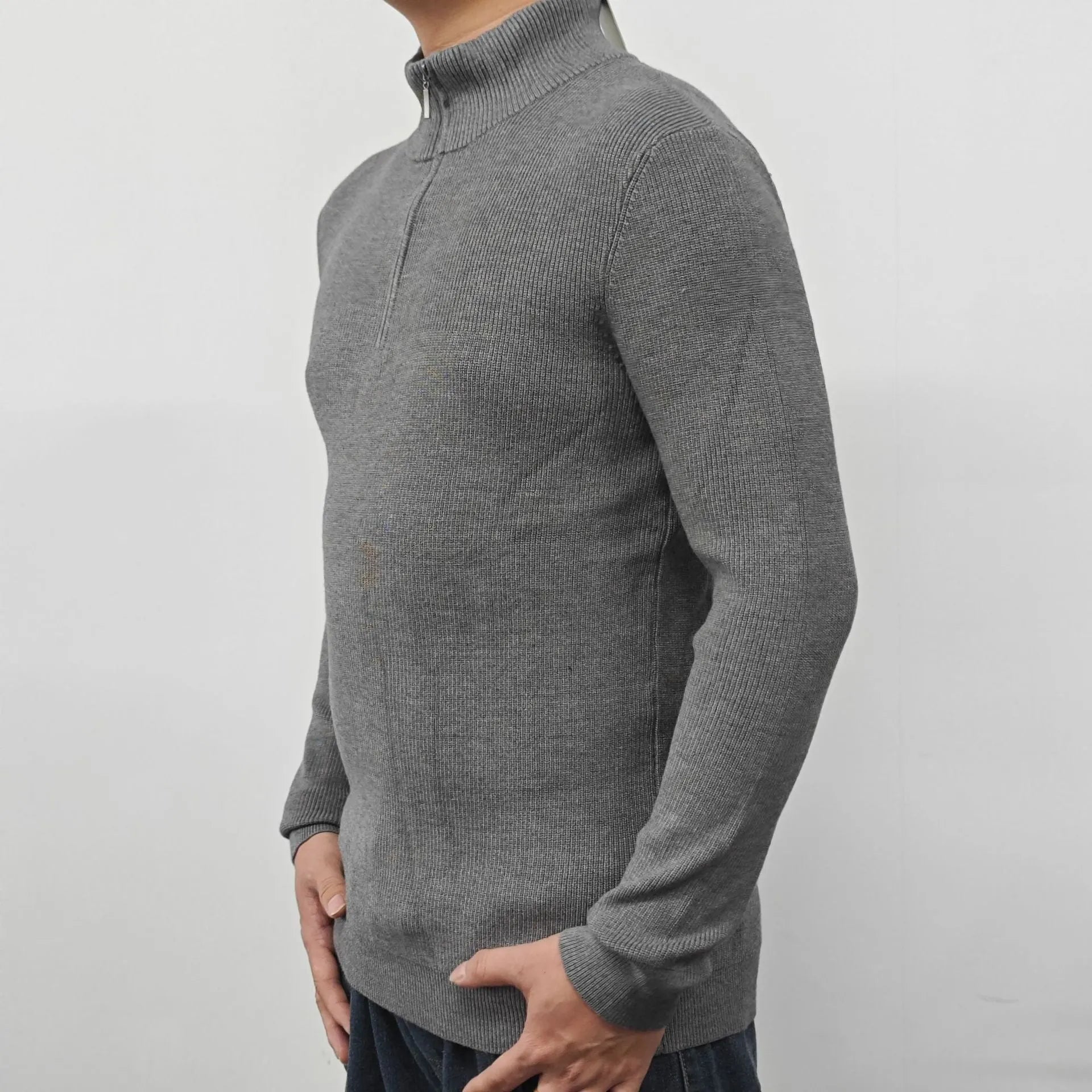 Man wearing a grey cotton blend half-turtleneck zip sweater with long sleeves