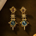 Gold alloy retro geometry stud earrings with round shape and diamond treatment.
