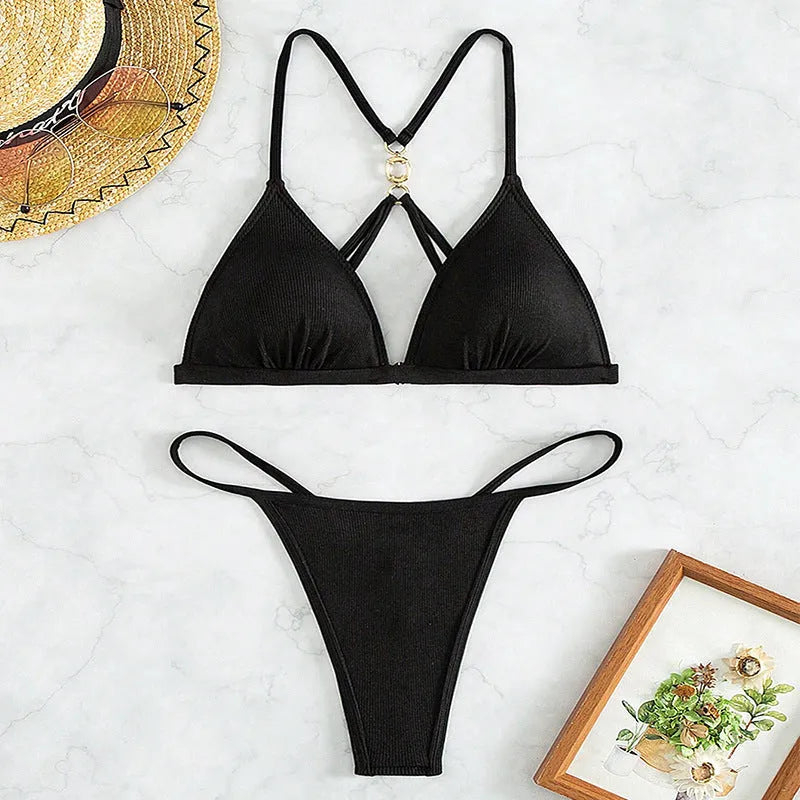 Black women's hollow backless triangle bikini top with matching high-cut briefs on a mannequin.