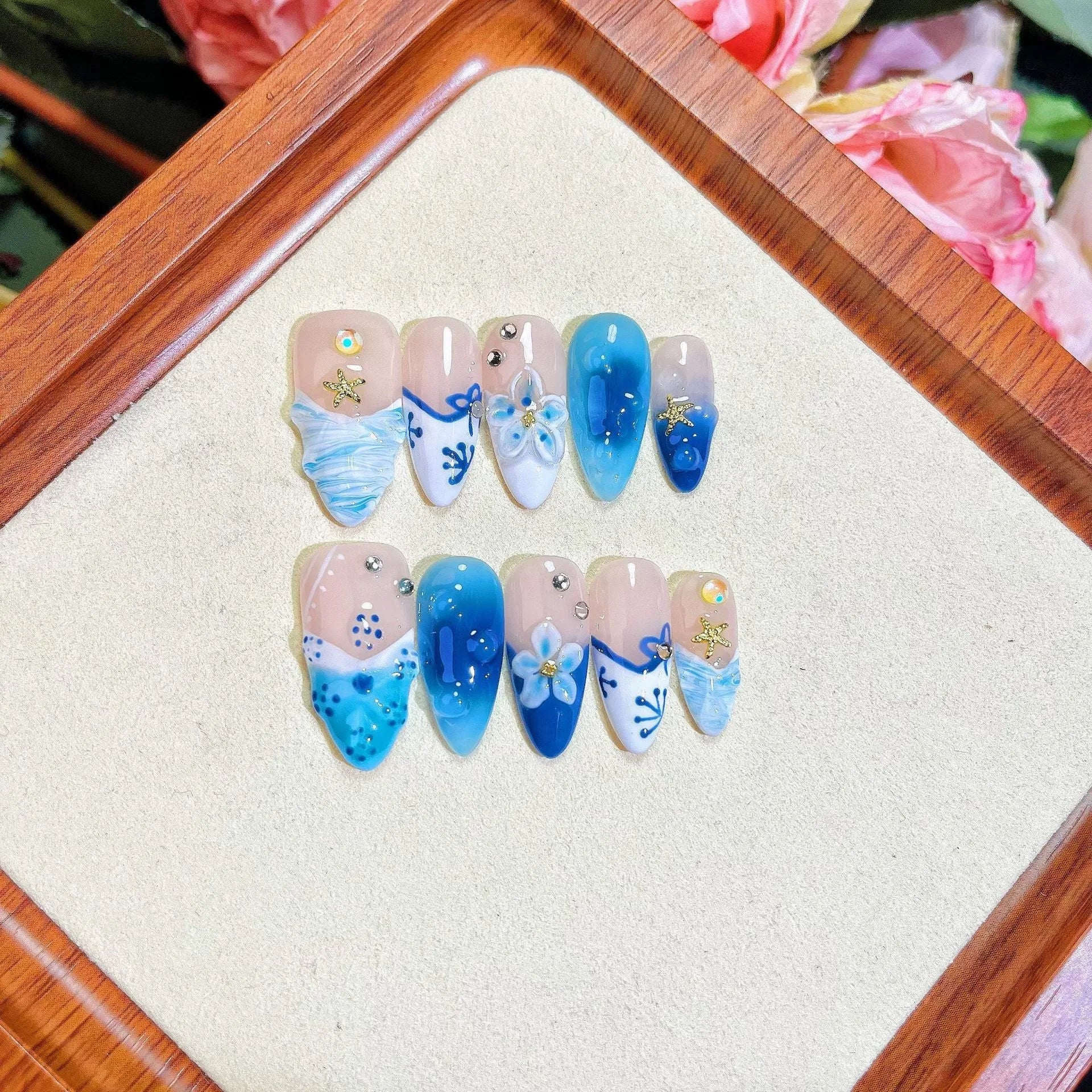 Blue hand-painted carved summer ice transparent plastic fake nails set in sizes XS, S, M, L.