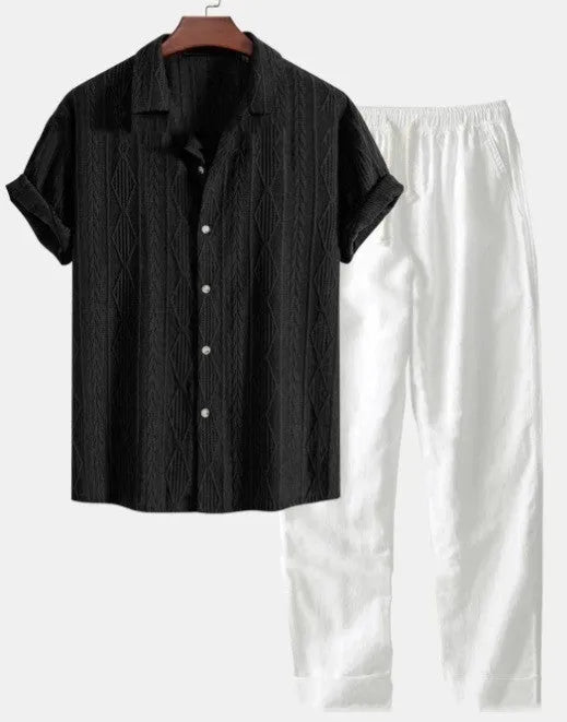 Man wearing a loose-fit light blue short sleeve shirt and matching trousers from a milk silk summer suit.