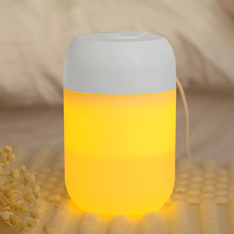 White cylindrical USB-powered mini humidifier with aromatherapy function on wooden desk