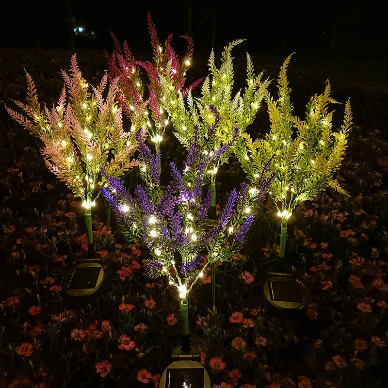 A pink flower-shaped solar LED garden light standing 74 cm tall in an outdoor setting.