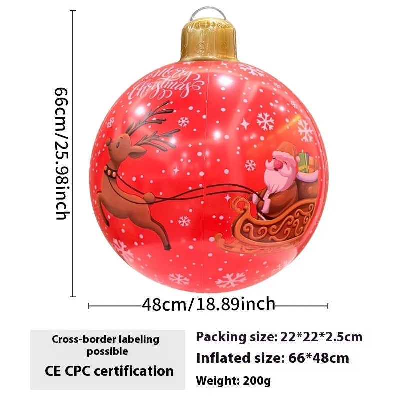 Large red inflatable Christmas ball with snowflake pattern and flash light, shown with a hand pump in a garden setting.