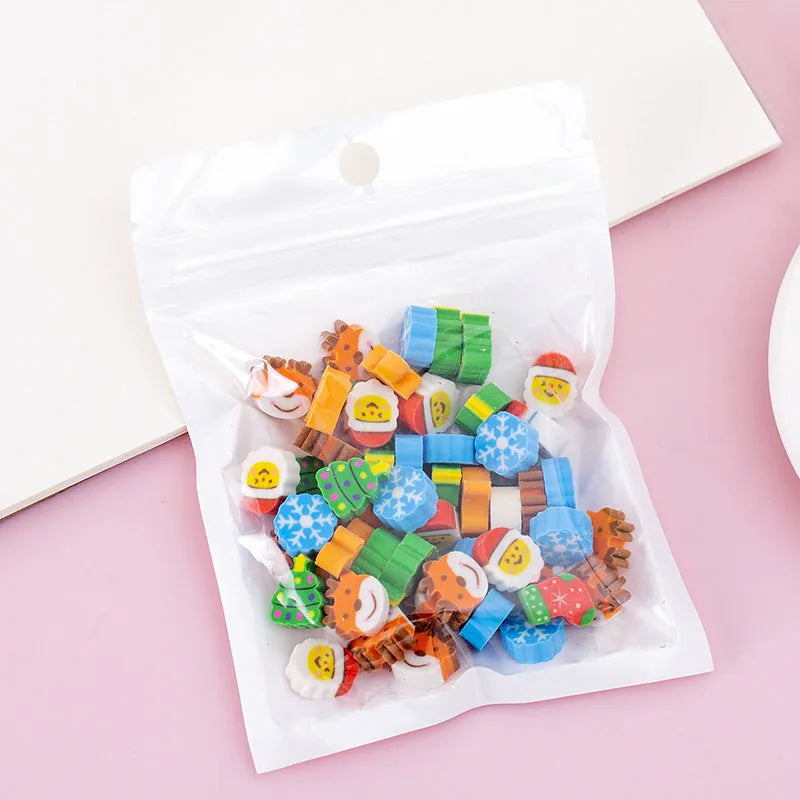 50 small colourful cartoon erasers in a pearlescent bag showing fruit, animal, cake, and Halloween themes.