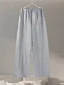Women's apricot colour polar fleece lounge suit featuring a long sleeve pleated top and wide-leg trousers.